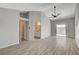 Bright bedroom with wood-look tile flooring, ceiling fan, neutral paint, and sliding glass doors at 4052 Compass Rose Way, Las Vegas, NV 89108