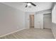 Bedroom featuring wood-look tile, a ceiling fan, a closet with sliding doors, and neutral walls at 4052 Compass Rose Way, Las Vegas, NV 89108