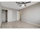 Bedroom featuring wood-look tile, a ceiling fan, and a closet with sliding doors at 4052 Compass Rose Way, Las Vegas, NV 89108