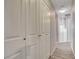 Hallway with multiple storage closets and wood-look flooring, offering ample storage solutions at 4052 Compass Rose Way, Las Vegas, NV 89108