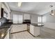 Bright kitchen features white cabinets, modern appliances, mosaic backsplash, and stylish countertops at 4052 Compass Rose Way, Las Vegas, NV 89108