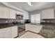 Beautiful kitchen with white cabinets, granite countertops, and stainless steel appliances at 4052 Compass Rose Way, Las Vegas, NV 89108