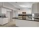 Bright kitchen features white cabinets, modern appliances, mosaic backsplash, and stylish countertops at 4052 Compass Rose Way, Las Vegas, NV 89108