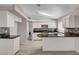 Bright kitchen featuring white cabinets, granite countertops, and stainless steel appliances at 4052 Compass Rose Way, Las Vegas, NV 89108