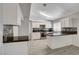 Bright kitchen features white cabinets, modern appliances, mosaic backsplash, and stylish countertops at 4052 Compass Rose Way, Las Vegas, NV 89108