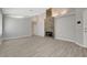 Open living room featuring wood-look tile flooring and a striking stone fireplace at 4052 Compass Rose Way, Las Vegas, NV 89108