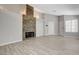 Open living room featuring wood-look tile flooring and a beautiful stone fireplace at 4052 Compass Rose Way, Las Vegas, NV 89108