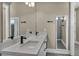 This bathroom features a double sink vanity, modern fixtures, and a large mirror with lighting at 460 Pear Lake St, Las Vegas, NV 89138
