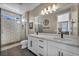 This bathroom features a double sink vanity with modern fixtures, a tile shower, and a large mirror with lighting at 460 Pear Lake St, Las Vegas, NV 89138