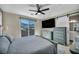 Bedroom featuring a sliding barn door, a large window with a view, and contemporary furnishings at 460 Pear Lake St, Las Vegas, NV 89138