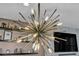 Modern chandelier with exposed bulbs, adding character to the home's interior at 460 Pear Lake St, Las Vegas, NV 89138