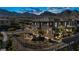 Contemporary two-story home featuring desert landscaping, exterior lighting, and mountain views at 460 Pear Lake St, Las Vegas, NV 89138
