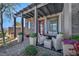 Inviting covered front porch with stylish decor and outdoor seating area at 460 Pear Lake St, Las Vegas, NV 89138