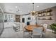 Modern kitchen flows into dining area with stylish light fixtures and shelving at 460 Pear Lake St, Las Vegas, NV 89138