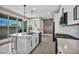 Beautiful kitchen featuring an island and black appliances, flowing to a patio at 460 Pear Lake St, Las Vegas, NV 89138