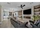 Expansive living area with a modern kitchen, dining area, and sleek fireplace at 460 Pear Lake St, Las Vegas, NV 89138