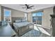 This spacious main bedroom features gray walls and a large sliding glass door that provides access to a private balcony at 460 Pear Lake St, Las Vegas, NV 89138