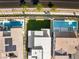Overhead view showcases a pristine backyard with lush grass, situated between homes with sparkling pools at 484 Windstone Crest Ave, Las Vegas, NV 89138