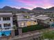 Aerial shot highlighting a backyard with lawn, patio, and mountain views, nestled in a vibrant community at 484 Windstone Crest Ave, Las Vegas, NV 89138