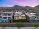 Backyard view featuring pool, patio, and outdoor kitchen set against a stunning mountain backdrop at 484 Windstone Crest Ave, Las Vegas, NV 89138