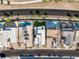 An aerial view of multiple modern homes, each boasting luxurious pools and meticulously landscaped yards at 484 Windstone Crest Ave, Las Vegas, NV 89138