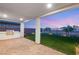 Covered patio with outdoor kitchen and grill overlooks an immaculate lawn and mountain views at 484 Windstone Crest Ave, Las Vegas, NV 89138