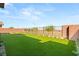 Large backyard offers a well-manicured lawn with desert landscaping and lighting at 484 Windstone Crest Ave, Las Vegas, NV 89138