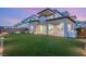 Spacious backyard featuring lush green grass, covered patio, and outdoor kitchen area at 484 Windstone Crest Ave, Las Vegas, NV 89138