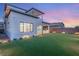 Beautiful, large backyard with lush lawn, BBQ, landscaped borders, and open patio with sunset views at 484 Windstone Crest Ave, Las Vegas, NV 89138