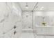 Bathroom featuring a glass shower, dual shower heads, double sinks, and white tile at 484 Windstone Crest Ave, Las Vegas, NV 89138