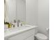 Well-lit half-bathroom featuring a sleek white sink, countertop, and modern fixtures at 484 Windstone Crest Ave, Las Vegas, NV 89138