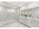Bathroom featuring a glass shower, dual shower heads, double sinks, and white tile at 484 Windstone Crest Ave, Las Vegas, NV 89138