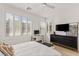 Bedroom with a large window, plantation shutters, and ceiling fan at 484 Windstone Crest Ave, Las Vegas, NV 89138