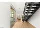Bright and airy foyer with modern staircase, wood floors, and sliding glass doors at 484 Windstone Crest Ave, Las Vegas, NV 89138