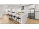 Bright kitchen featuring stainless steel appliances, a large island, and modern barstools at 484 Windstone Crest Ave, Las Vegas, NV 89138