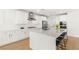 Contemporary kitchen features a spacious island with seating, white cabinets, and modern stainless steel appliances at 484 Windstone Crest Ave, Las Vegas, NV 89138