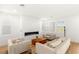 Bright living room with large windows, comfortable seating, and a stylish fireplace at 484 Windstone Crest Ave, Las Vegas, NV 89138
