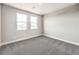 A carpeted bedroom features two windows and neutral walls at 522 Copper Falcon Ave, Henderson, NV 89011