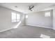 Inviting bedroom featuring plush carpeting, multiple windows, and modern ceiling fan at 522 Copper Falcon Ave, Henderson, NV 89011