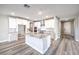 Gourmet kitchen with granite countertops, white cabinets, stainless steel appliances and a large center island at 522 Copper Falcon Ave, Henderson, NV 89011