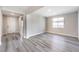 Bright, open-concept living room featuring gray wood flooring, recessed lighting, and lots of natural light at 522 Copper Falcon Ave, Henderson, NV 89011