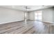 Bright living room featuring luxury vinyl plank flooring, ceiling fan, and sliding glass doors to the backyard at 522 Copper Falcon Ave, Henderson, NV 89011