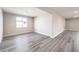 Spacious living room with modern gray wood flooring, neutral paint and bright natural light at 522 Copper Falcon Ave, Henderson, NV 89011