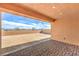 A covered patio with brick pavers overlooks a spacious backyard and mountain views in the distance at 522 Copper Falcon Ave, Henderson, NV 89011