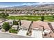 Expansive aerial view of desert community with lush golf course and mountain backdrop at 5260 Acqua Ln, Pahrump, NV 89061