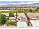 Attractive single-Gathering home featuring a spacious three-car garage and manicured landscaping at 5260 Acqua Ln, Pahrump, NV 89061