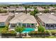 Backyard aerial view with a private pool, lush landscaping, and a covered patio at 5260 Acqua Ln, Pahrump, NV 89061
