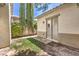 Cozy private backyard space featuring a small lawn area, sliding glass door, and tall trees at 5260 Acqua Ln, Pahrump, NV 89061