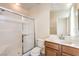 Bright bathroom with vanity, large mirror, and a glass-enclosed shower at 5260 Acqua Ln, Pahrump, NV 89061