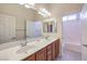 Bright bathroom features a large double sink vanity and a shower-tub at 5260 Acqua Ln, Pahrump, NV 89061